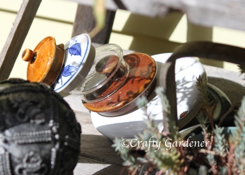 a craf-tea idea - old teapot lids stacked up- craftygardener.ca