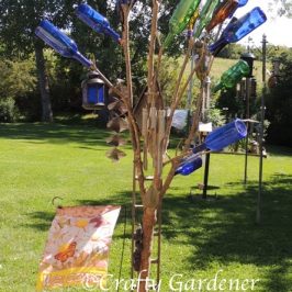 converting an old lilac bush into a bottle tree at craftygardener.ca